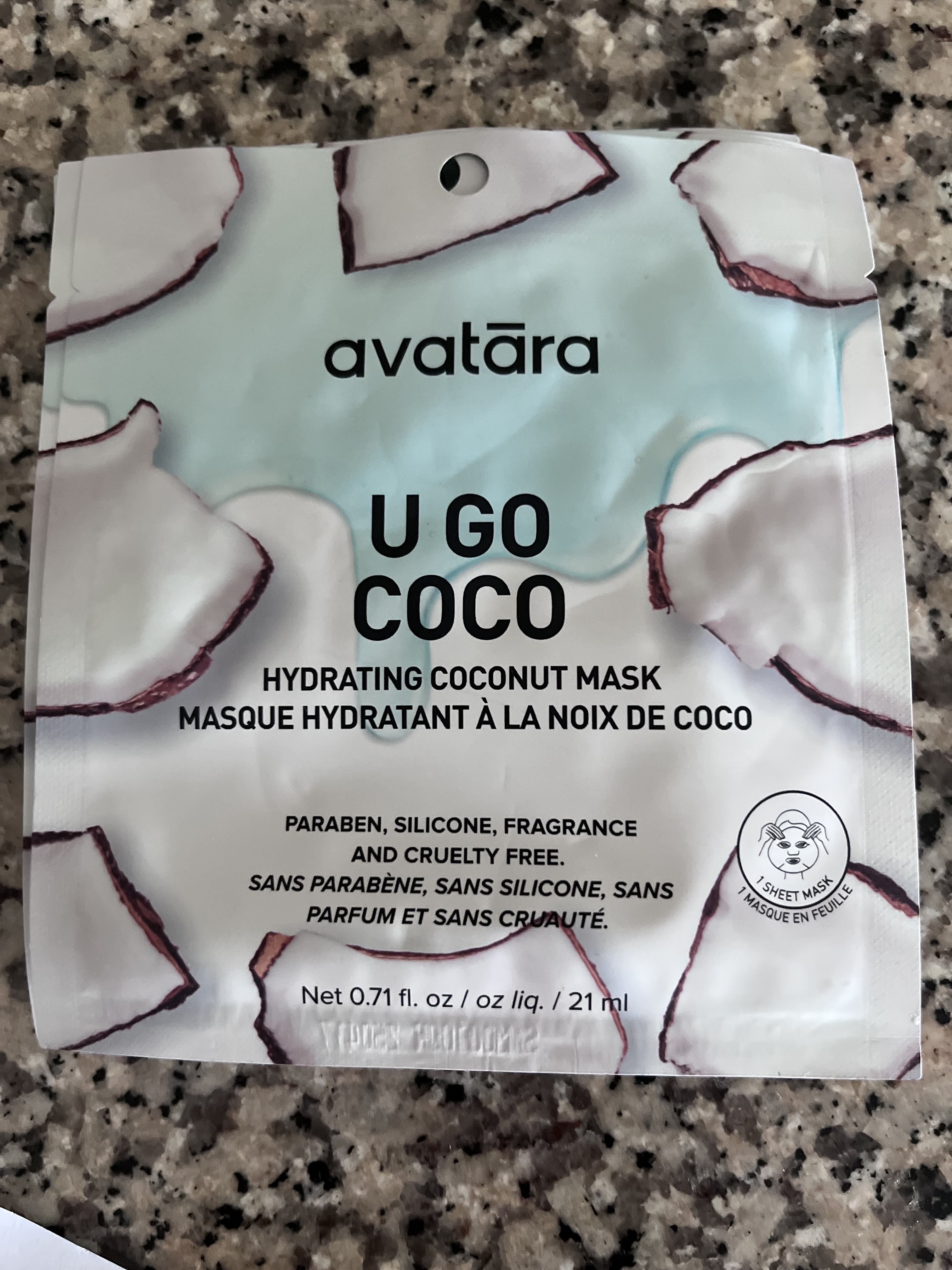 Packet of Avatara “U Go Coco” hydrating coconut sheet mask displayed on a granite countertop, showing coconut pieces on the packaging and text noting it is paraben, silicone, fragrance, and cruelty free, 0.71 fl oz (21 ml).