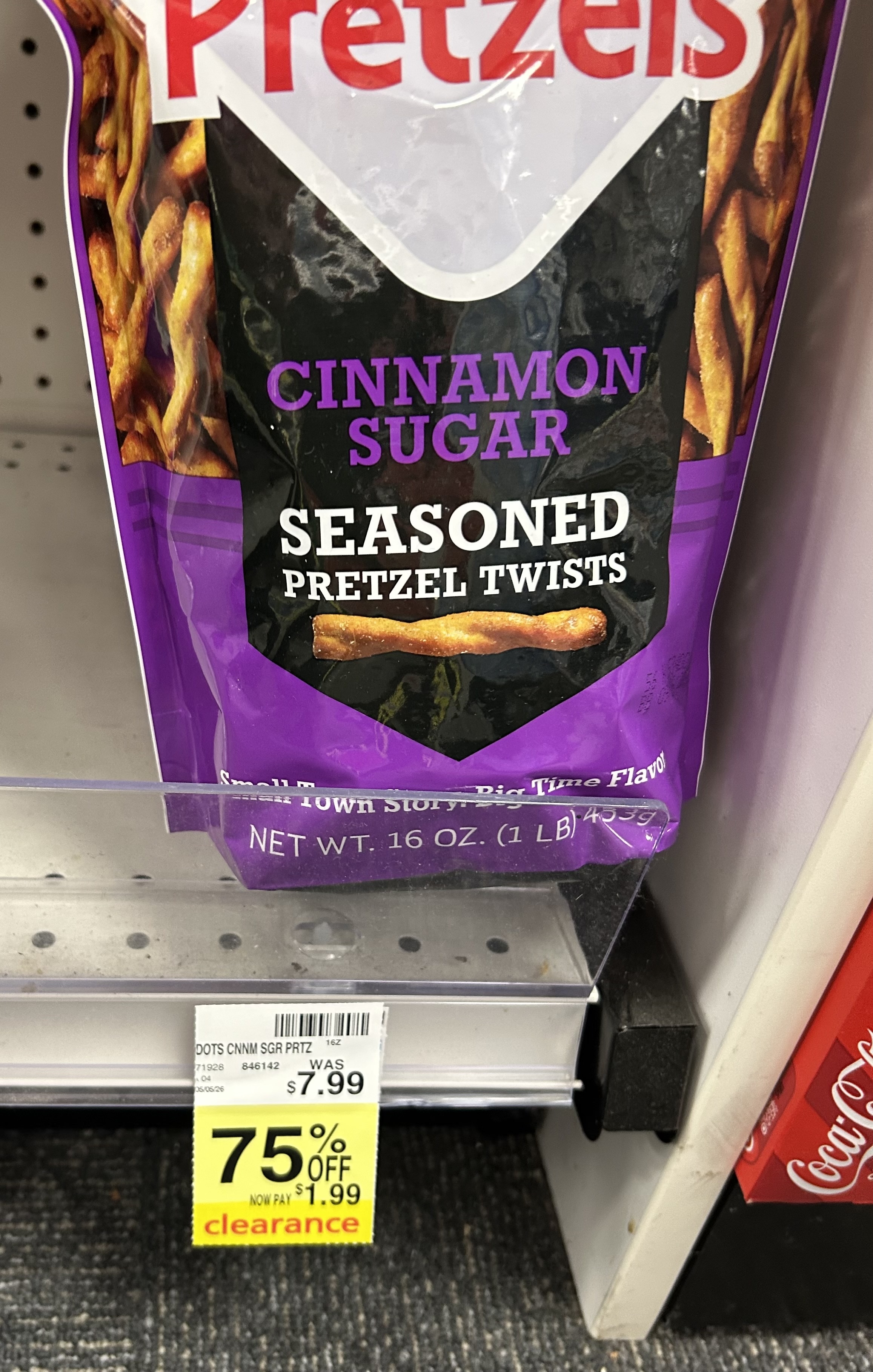 large bag of Dot’s cinnamon sugar seasoned pretzel twists on a store shelf with a yellow clearance tag showing 75% off, reduced from $7.99 to $1.99